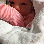 Harmony is registered to the contest to win money with this photo: newborn, baby, blanket, hat, bow, pink_clothing, wrapped, cozy, infant, cute, face, eyes, sleepwear, soft, indoor, closeup, portrait, child, newborn_hat, baby_burrito