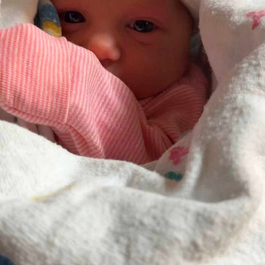 Harmony is registered to the contest to win money with this photo: newborn, baby, blanket, hat, bow, pink_clothing, wrapped, cozy, infant, cute, face, eyes, sleepwear, soft, indoor, closeup, portrait, child, newborn_hat, baby_burrito