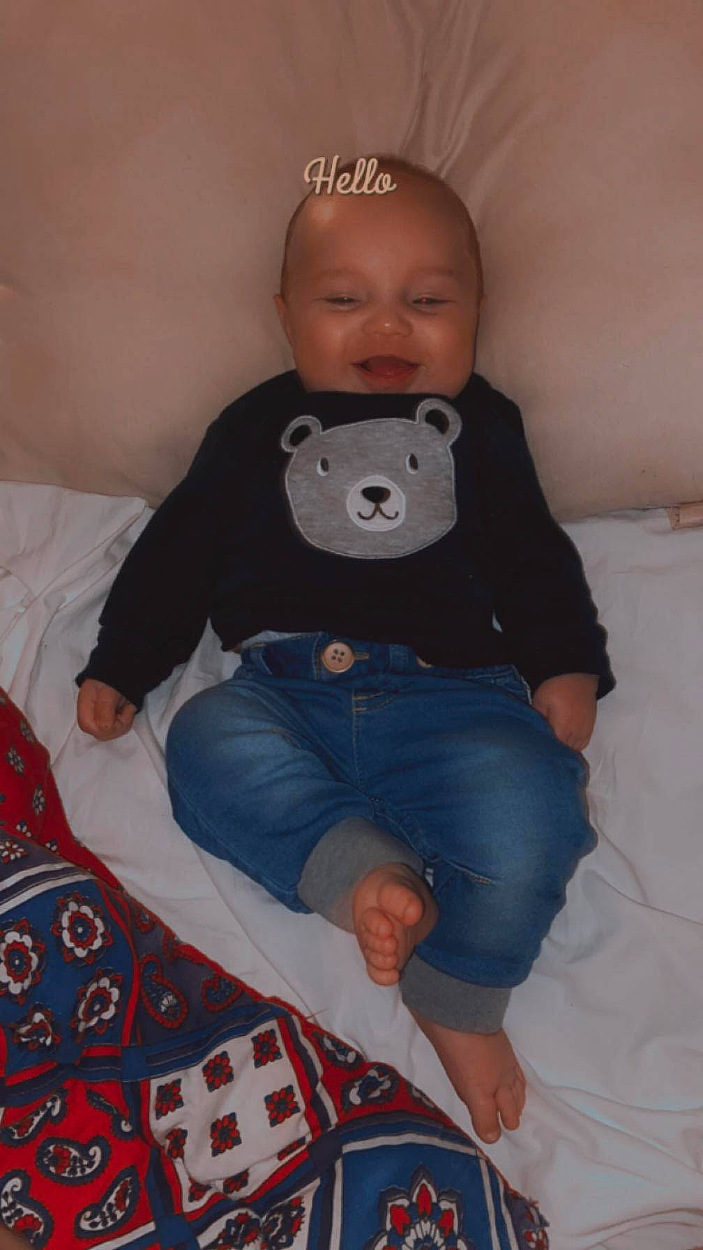 Cashton is registered to the contest to win money with this photo: baby, baby_toddler_clothing, cheek, child, comfort, face, head, human_body, human_leg, jeans, knee, lap, linens, person, skin, sleeve, smile, sock, t_shirt, thigh