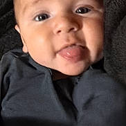 Khamilo joined the competition — help win amazing prizes! baby, blanket, child, close_up, clothing, cozy, cute, expression, face, gray_clothing, indoor, infant, looking_at_camera, lying_down, photography, portrait, sitting, sticking_out_tongue, tongue, wrapped