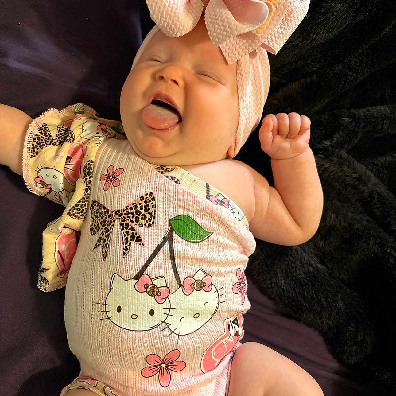 Blayre joined the competition — help win amazing prizes! baby, child, infant, headband, bow, tongue_out, smiling, cute, hello_kitty, onesie, clothing, pink, flower, pattern, lying_down, blanket, happy, skin, chubby, portrait