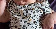 Blayre joined the competition — help win amazing prizes! baby, infant, onesie, floral_pattern, smiling, tongue_out, lying_down, purple_blanket, cute, chubby, skin, head, hand, arm, face, person, child, expression, indoors, adorable