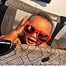 Xaniah Rose joined the competition — help win amazing prizes! baby, child, sunglasses, red_sunglasses, playpen, smile, happy, hand, face, indoor, curtain, fabric, pattern, person, cute, young_child, expression, head, skin, fun