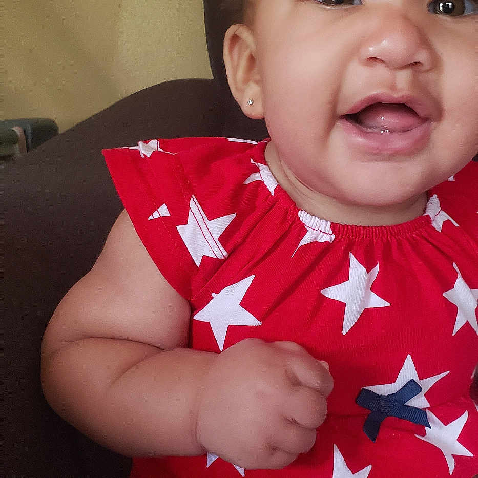 Saige joined the competition — help win amazing prizes! baby, babylaughing, bodypart, clothing, couch, cushion, face, finger, frown, furniture, hand, happy, head, homedecor, person, photography, portrait, sad, sitting, t_shirt