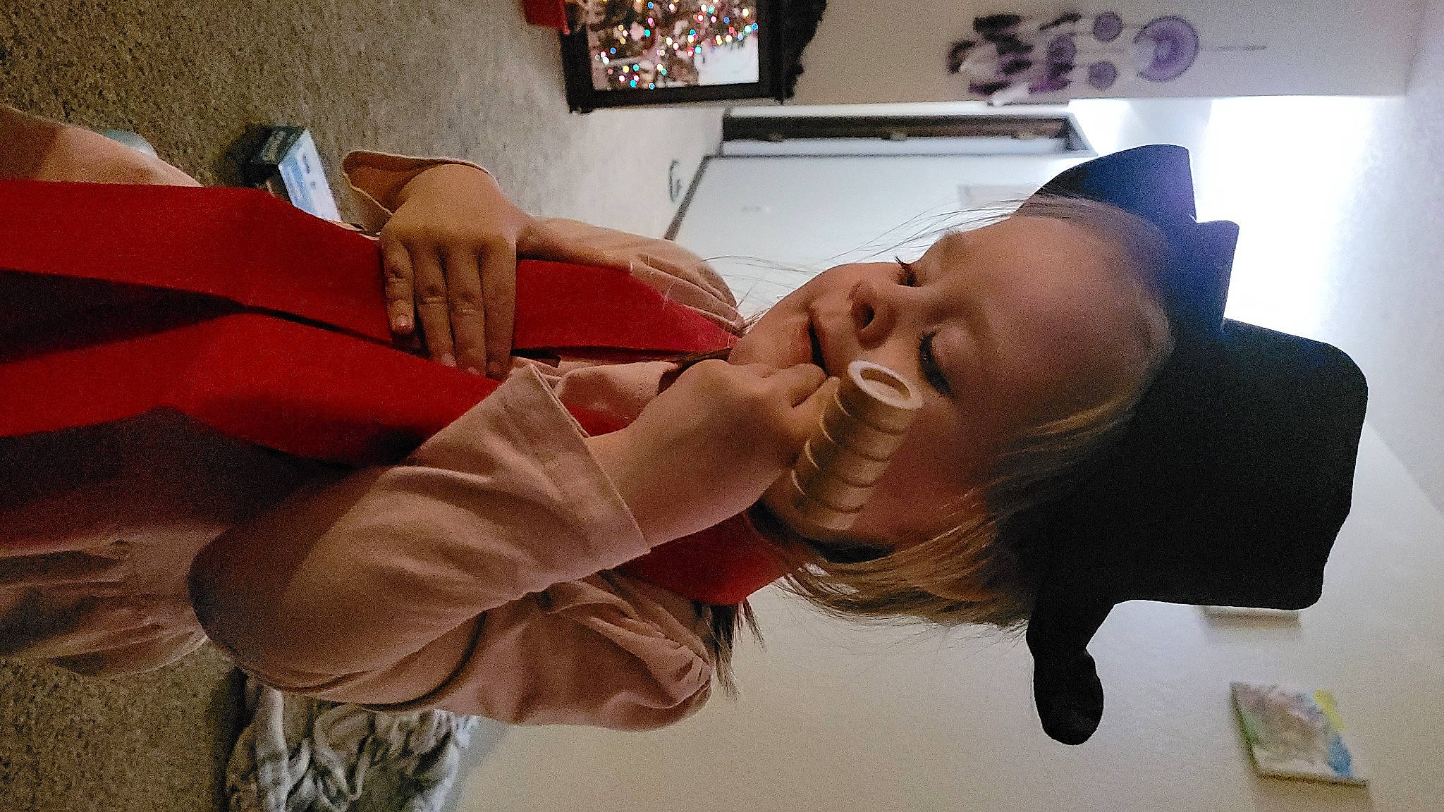 Karlie is registered to the contest to win money with this photo: child, comfort, elbow, eyelash, eyewear, finger, flesh, fun, happy, human_leg, mouth, neck, person, picture_frame, room, sitting, smile, toddler, vacation, wood