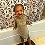 toddler, child, smiling, barefoot, bathroom, bathtub, shower_curtain, pattern, floor_tile, black_mat, clothing, striped_dress, hair, braids, happy, standing, young_child, indoors, person, cute