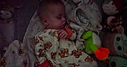 Hunter is registered to the contest to win money with this photo: baby, sleeping, blanket, plush_toys, onesie, bedtime, cozy, child, stuffed_animals, soft_lighting, comfort, indoor, cute, rest, infant, toddler, colorful, peaceful, nursery, sleep