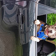 Athena is registered to the contest to win money with this photo: art, auto_part, automotive_exterior, automotive_tire, electric_blue, fun, glass, leisure, metal, motor_vehicle, recreation, smile, toy, train, tree, vehicle, vehicle_door, visual_arts, wood