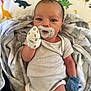 Noah-Jude joined the competition — help win amazing prizes! baby, newborn, pacifier, mittens, blanket, onesie, infant, dinosaur_pattern, sleepwear, cute, lying_down, soft_texture, handwear, striped_clothing, colorful_background, portrait, child, indoor, face, closeup