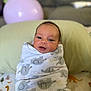 Noah-Jude is registered to the contest to win money with this photo: newborn, baby, blanket, swaddle, infant, face, eyes, couch, pillow, balloon, soft_texture, pattern, child, indoors, cute, lying_down, resting, happy, cozy, portrait