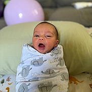 Noah-Jude is registered to the contest to win money with this photo: newborn, baby, blanket, wrapped, face, infant, couch, pillow, balloon, indoor, soft, cute, child, portrait, expression, home, comfort, pattern, resting, young