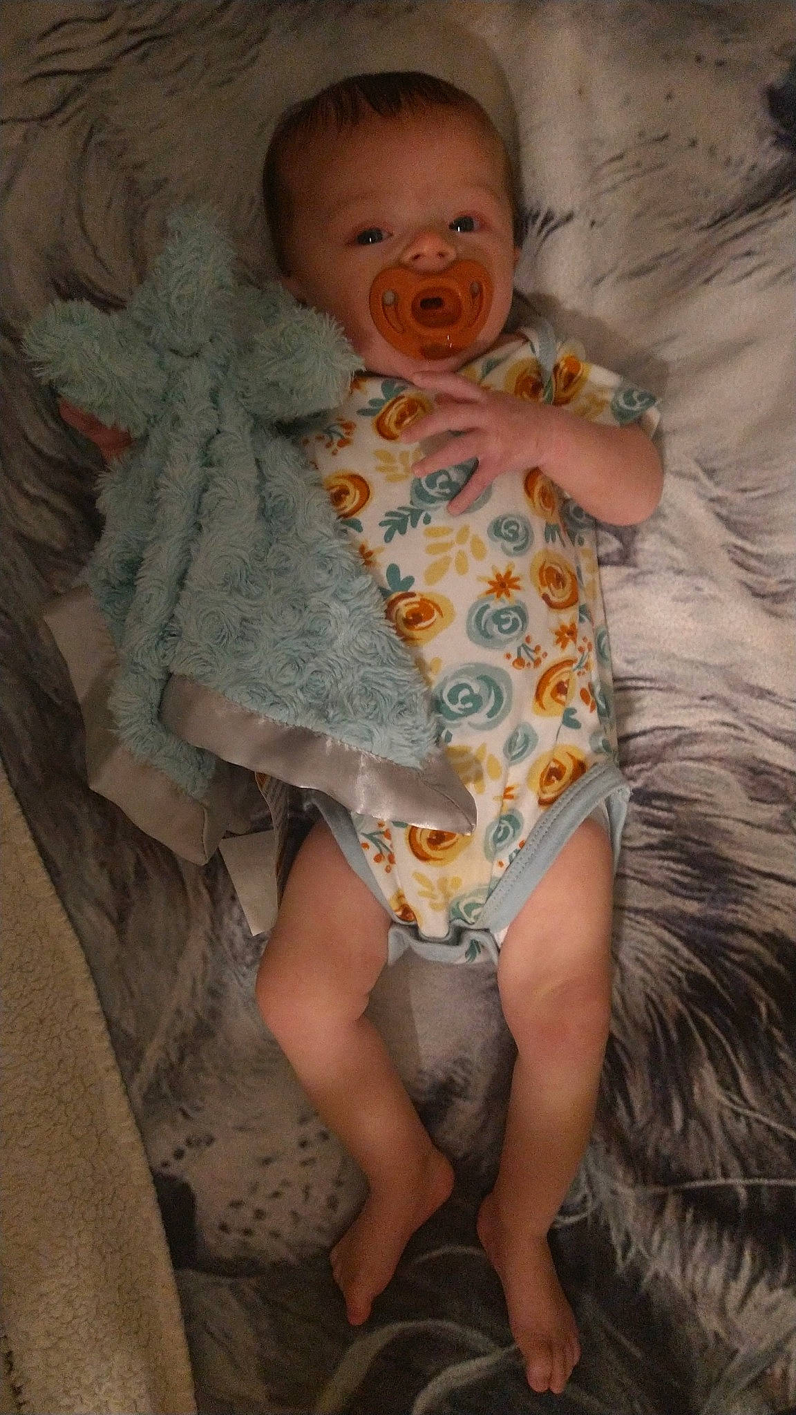 Taylor is registered to the contest to win money with this photo: arm, baby, baby_toddler_clothing, child, comfort, eye, finger, hand, happy, human_body, iris, mouth, neck, pattern, person, skin, sleeve, smile, textile, thigh