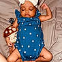 Kenza is registered to the contest to win money with this photo: baby, sleeping, headband, bow, blue_outfit, stars, plush_toy, mushroom, smile, hand, legs, feet, skin, bed, blanket, comfort, peaceful, infant, cute, resting