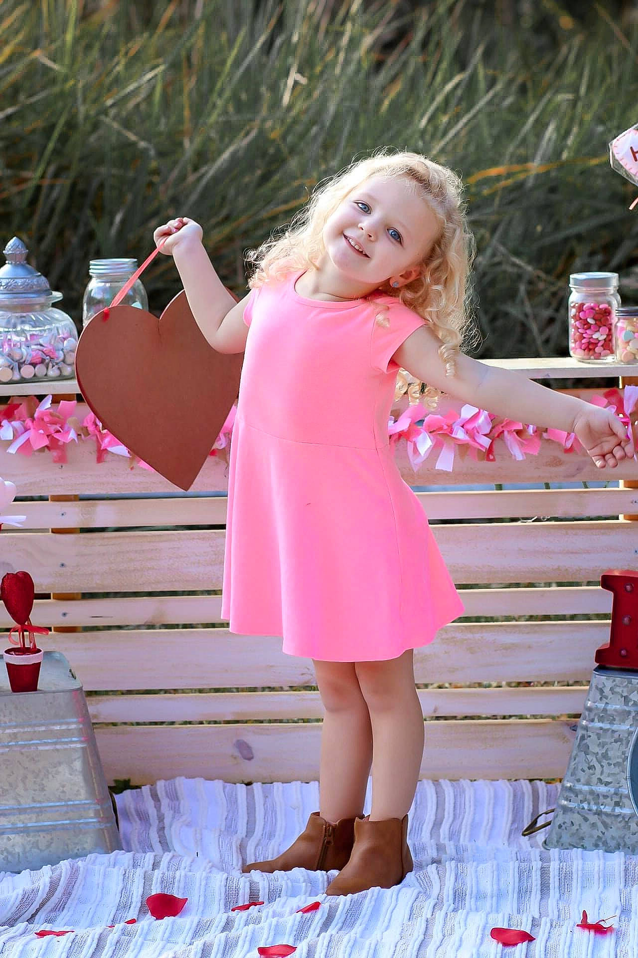 Ava is registered to the contest to win money with this photo: dress, facial_expression, flash_photography, grass, hairstyle, hand, happy, joy, leg, leisure, magenta, people_in_nature, person, pink, plant, red, skin, smile, standing, summer