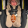 baby, infant, child, car_seat, football, bear_suit, hood, 冬服, safety_harness, seated, portrait, indoor, wood_floor, black_car_seat, fluffy_clothing, cute, face, looking_at_camera, infant_carrier, photography