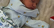 Deacon is registered to the contest to win money with this photo: baby, bedding, bees, blanket, clothing, cozy, crib, dinosaurs, face, indoors, infant, newborn, nursery, onesie, patterned, peaceful, portrait, resting, sleeping, swaddle