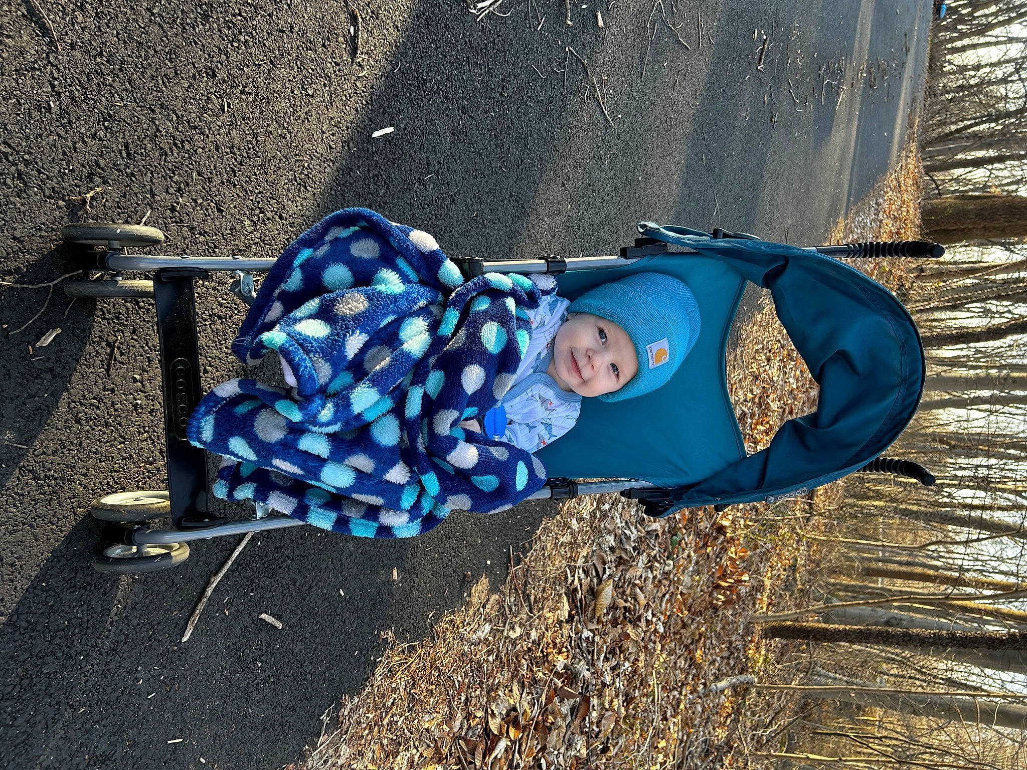 Luka is registered to the contest to win money with this photo: asphalt, baby, city, concrete, electric_blue, fun, grass, headwear, leisure, people_in_nature, person, public_space, road_surface, shadow, sitting, smile, soil, tints_and_shades, toddler, tree