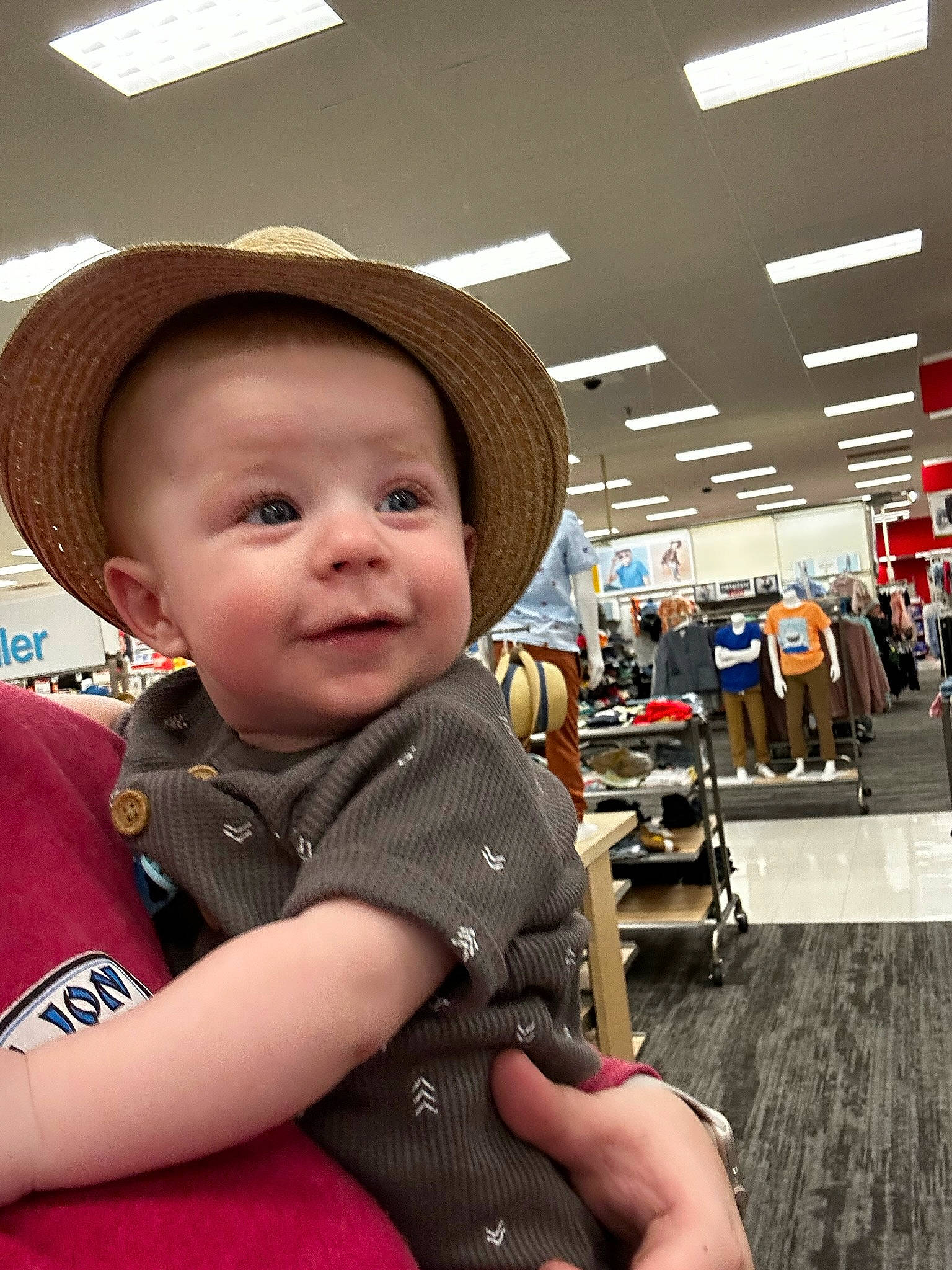 Luka is registered to the contest to win money with this photo: baby, cap, child, city, fashion_accessory, fun, happy, hat, headgear, leisure, person, portrait_photography, recreation, retail, sitting, skin, smile, sun_hat, toddler, tree