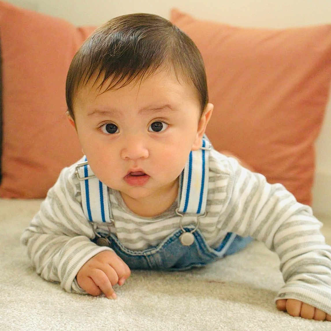 Suryan joined the competition — help win amazing prizes! baby, carpet, child, clothing, cushion, cute, denim, expression, eyes, face, floor, hand, indoor, infant, overalls, person, portrait, skin, striped_shirt, young