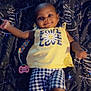 Lay Ani is registered to the contest to win money with this photo: baby, child, infant, smile, yellow_shirt, flower, love_text, blue_shorts, checkered_pattern, pacifier, blanket, patterned_blanket, lying_down, happy, sparkle_effect, indoors, cute, portrait, small_child, clothing