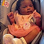 baby, infant, car_seat, bib, giraffe_pattern, tutu, pink, white_booties, blanket, teddy_bear_pattern, clothing, person, cute, child, indoor, portrait, seat, newborn, soft_toys, comfort