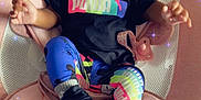 Lay Ani is registered to the contest to win money with this photo: baby, infant, child, puma, colorful_clothing, hair_bows, black_shoes, pink_cushion, seat, indoor, sparkles, cute, portrait, relaxing, fashion, legs, hands, smiling, face, person