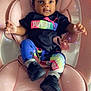 baby, infant, child, puma, colorful_clothing, hair_bows, black_shoes, pink_cushion, seat, indoor, sparkles, cute, portrait, relaxing, fashion, legs, hands, smiling, face, person