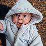 baby, child, hood, coat, fleece, outdoor, autumn, leaves, face, portrait, cute, winter_clothing, bundle_up, young_child, blue_eyes, skin, person, warm_clothing, nature, seasonal