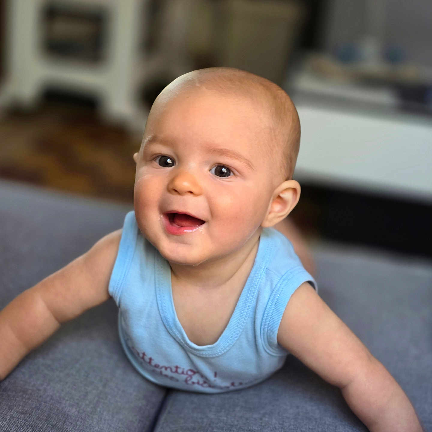 Raylon a rejoint le concours — aidez-le/la à gagner de superbes lots ! arm, baby, background_blur, child, clothing, couch, expression, eyes, face, furniture, happy, head, indoor, infant, mouth, person, skin, sleeveless_shirt, smiling, toddler