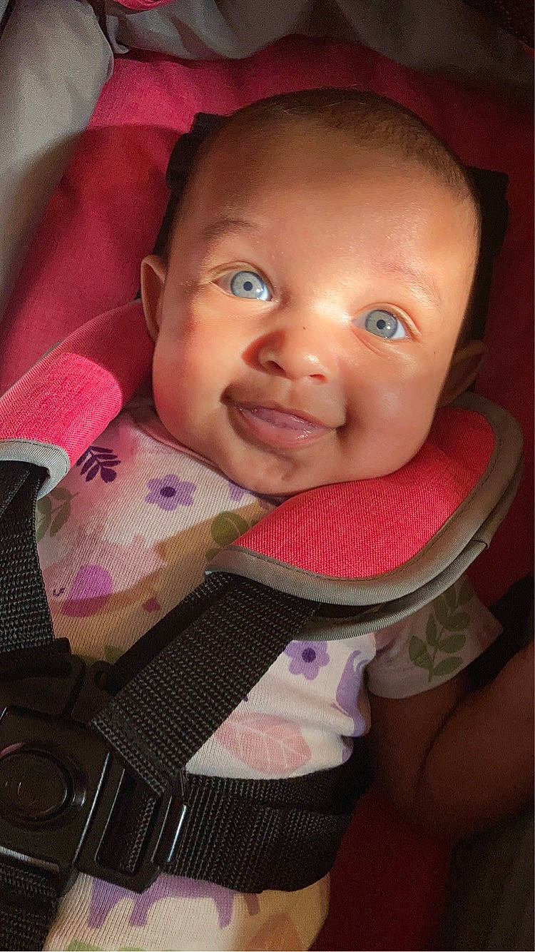 Lailah is registered to the contest to win money with this photo: baby, baby_carriage, baby_toddler_clothing, cheek, chin, comfort, ear, eyebrow, eyelash, facial_expression, happy, iris, lip, nose, person, pink, product, skin, smile, textile