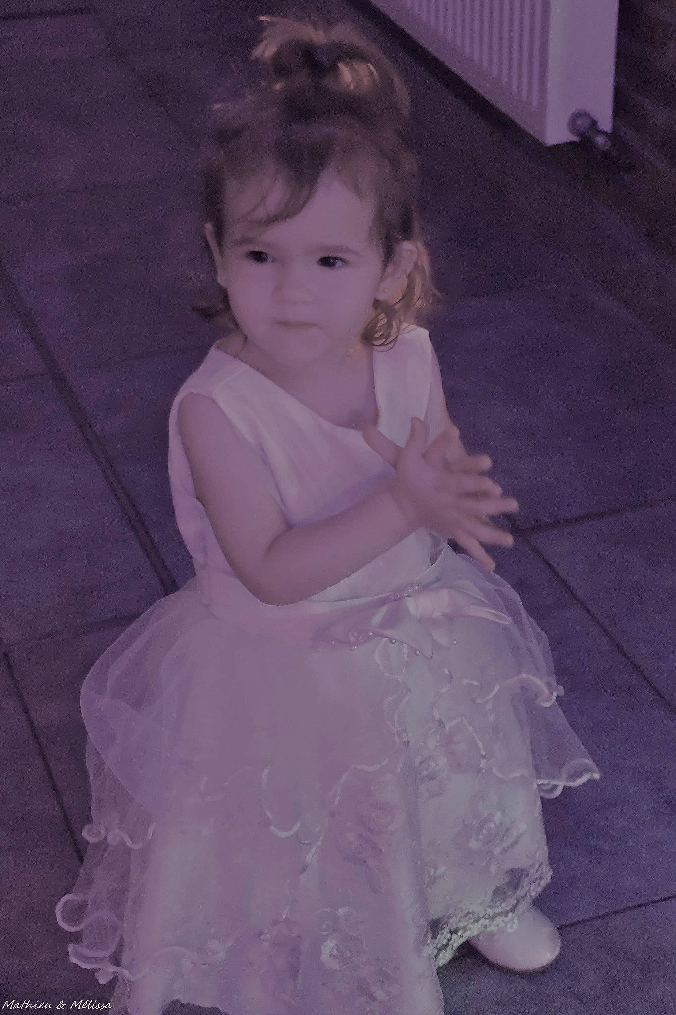 Andréa participe au concours pour gagner de l'argent avec cette photo : arm, baby, baby_toddler_clothing, bridal_accessory, day_dress, dress, embellishment, event, flooring, happy, human_body, iris, magenta, monochrome, pattern, person, purple, sitting, smile, toddler