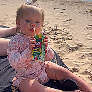 Serenity joined the competition — help win amazing prizes! barefoot, beach, blanket, cereal, child, cute, daylight, drinking, juice_box, ocean, outdoor, person, pink_clothing, relaxing, sand, sitting, sunny, toddler, water, waves