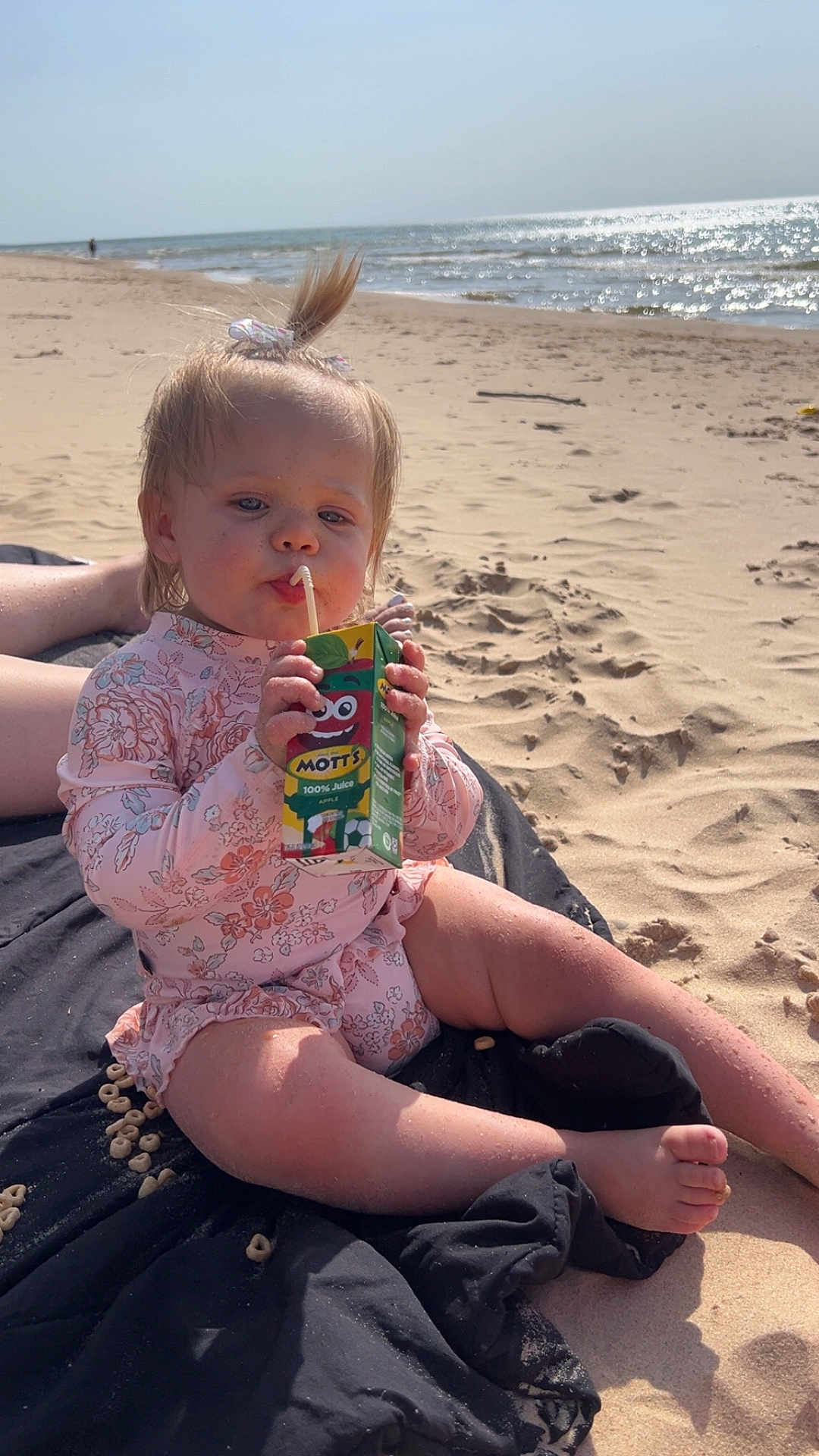 Serenity joined the competition — help win amazing prizes! barefoot, beach, blanket, cereal, child, cute, daylight, drinking, juice_box, ocean, outdoor, person, pink_clothing, relaxing, sand, sitting, sunny, toddler, water, waves