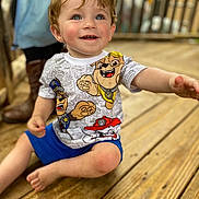 Anthony joined the competition — help win amazing prizes! child, toddler, smiling, blue_eyes, short_hair, paw_patrol, tshirt, blue_shorts, barefoot, wooden_deck, outdoor, person, happy, cute, sitting, reaching, playful, casual_clothing, daylight, fun