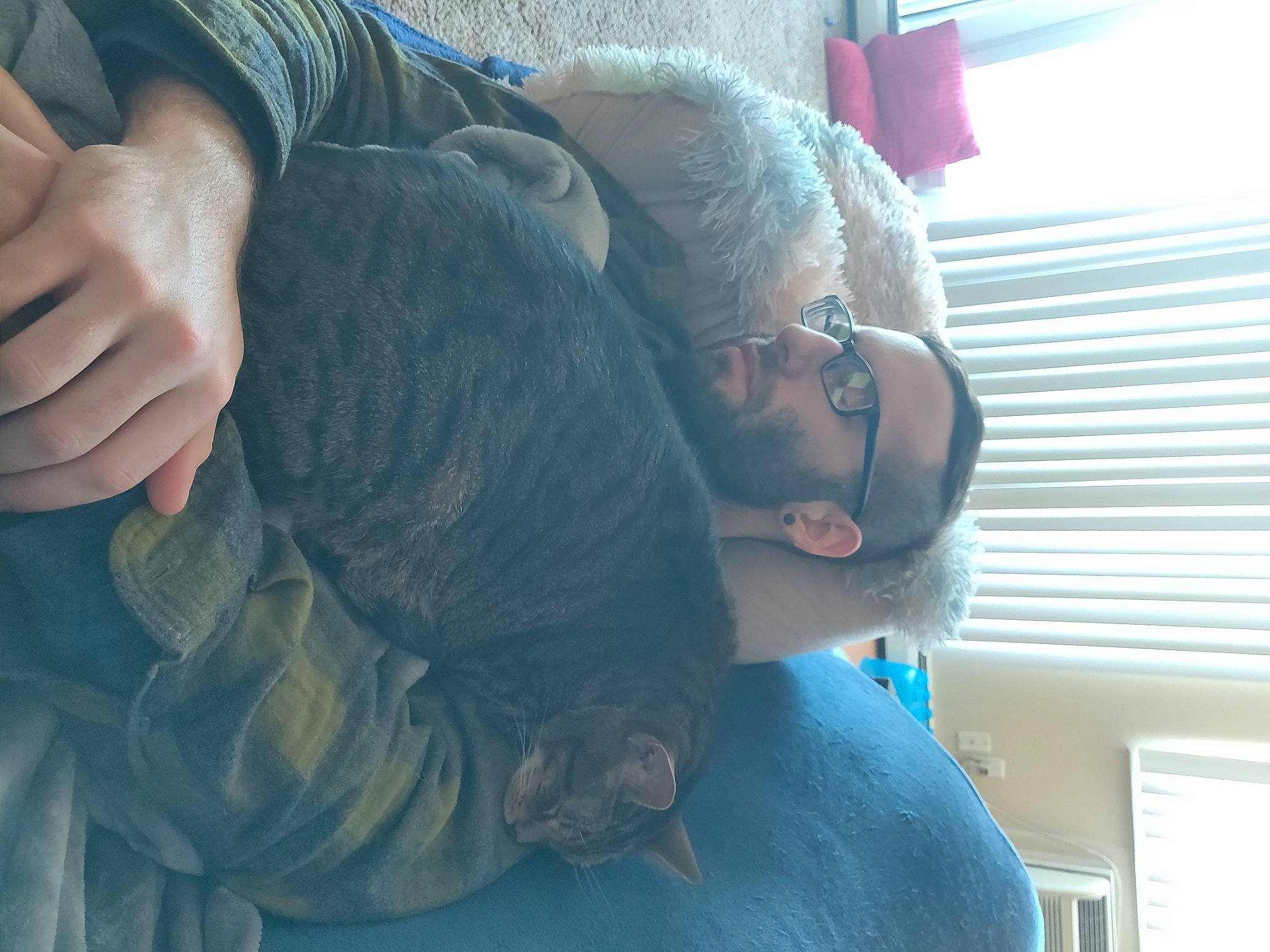 Edward is registered to the contest to win money with this photo: beard, black_hair, blue, comfort, cool, elbow, eyewear, fun, gesture, glasses, human_leg, knee, long_hair, mouth, neck, shoulder, textile, thigh, trunk, vision_care