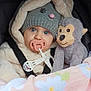 baby, blanket, blue_eyes, car_seat, child, coat, cute, floral_blanket, fur_coat, hat, indoors, infant, knit_hat, monkey_toy, pacifier, plush_toy, portrait, straps, warm, winter_clothing
