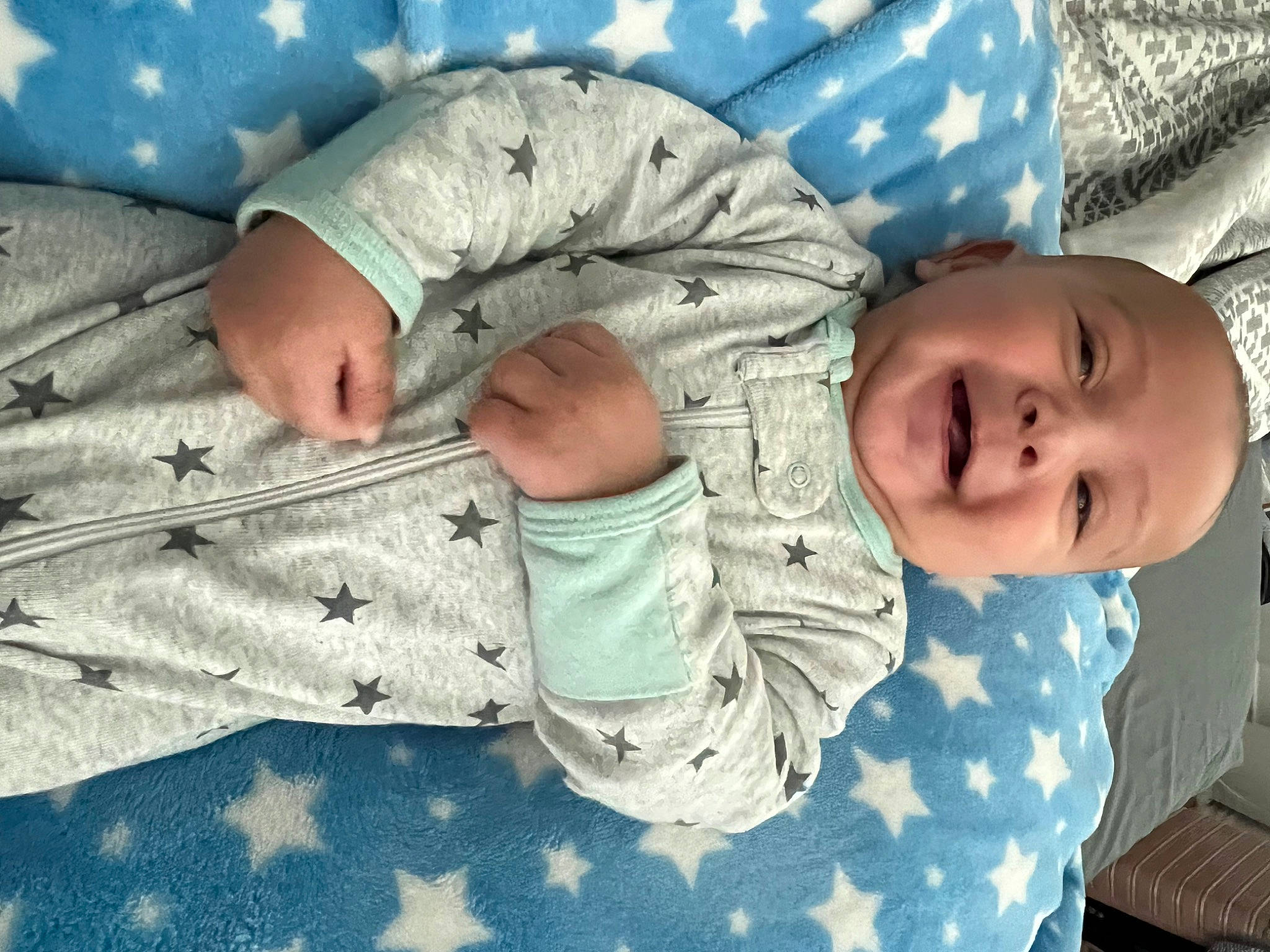 Kai is registered to the contest to win money with this photo: baby, baby_products, baby_toddler_clothing, child, comfort, finger, gesture, hand, leaf, leg, linens, military_camouflage, pattern, person, skin, sleeve, textile, thumb, toddler, tree