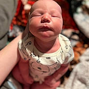 Rowan is registered to the contest to win money with this photo: accessories, adult, baby, blanket, clothing, face, glove, head, jewelry, male, man, necklace, newborn, person, photography, portrait, quilt, sleeping, towel