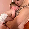 Vinny joined the competition — help win amazing prizes! baby, man, tattoo, diaper, sleeping, holding, skin, arm, indoor, person, child, closeup, love, care, family, parent, comfort, peaceful, tender, warm_lighting
