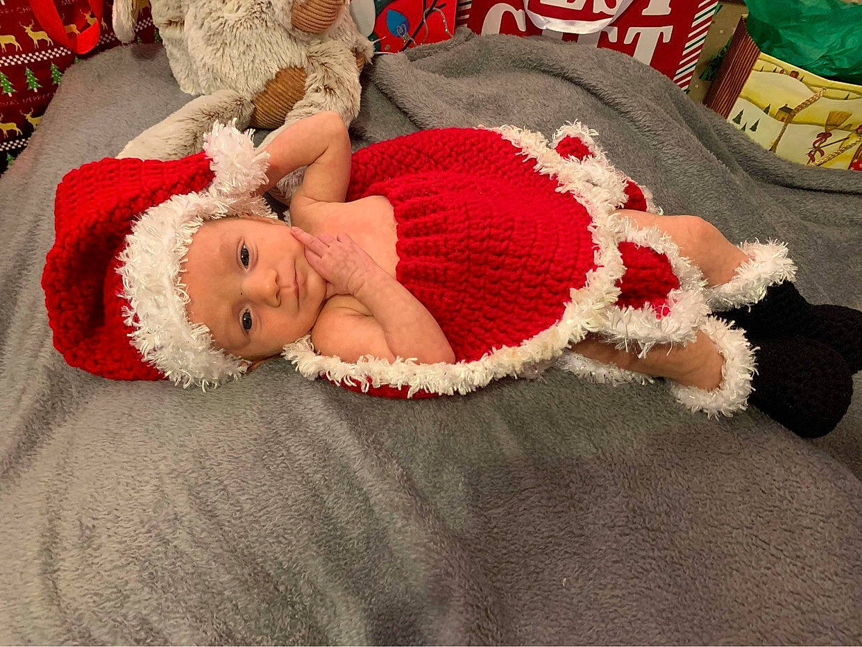 Alia joined the competition — help win amazing prizes! baby, baby_sleeping, baby_toddler_clothing, comfort, costume_hat, event, fawn, flooring, fur, hat, head, headwear, human_body, lap, leg, linens, person, red, thigh, toddler