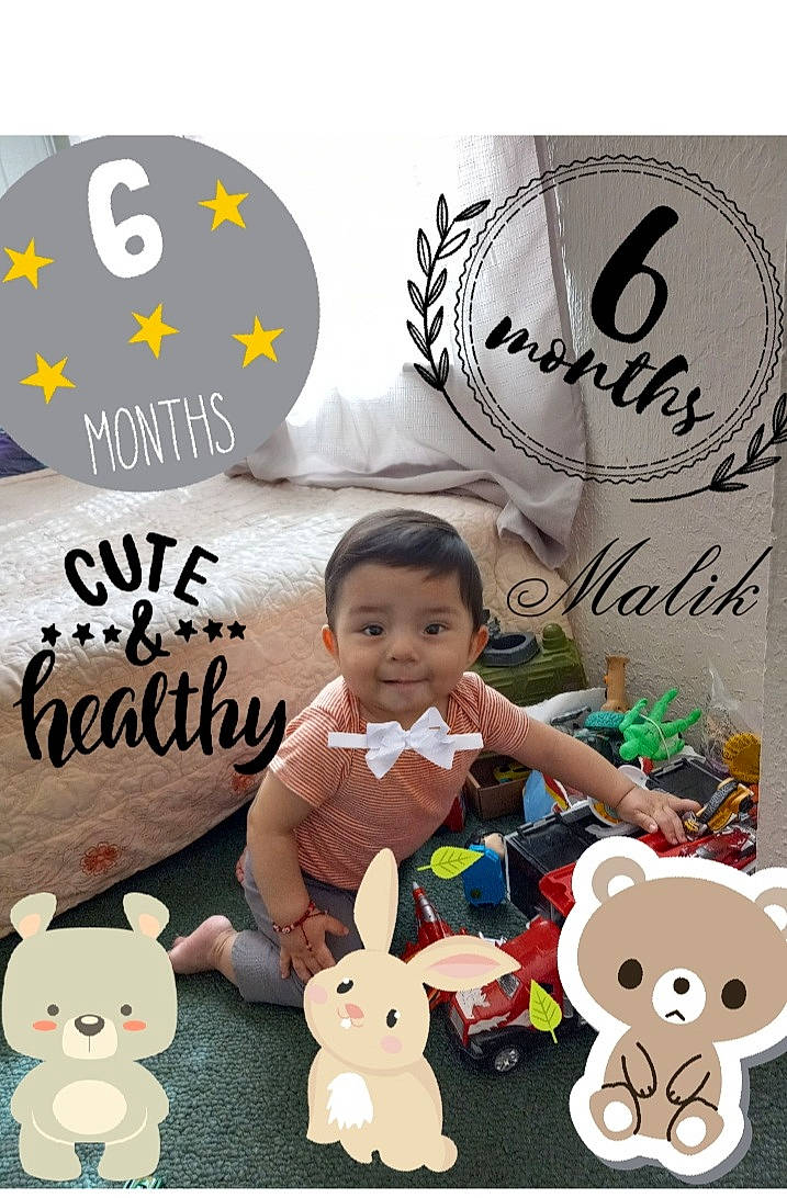 Oriel Malik is registered to the contest to win money with this photo: advertising, baby, baby_toddler_clothing, child, christmas, facial_expression, font, fun, handwriting, happy, holiday, joy, logo, person, product, room, smile, stuffed_toy, t_shirt, toddler