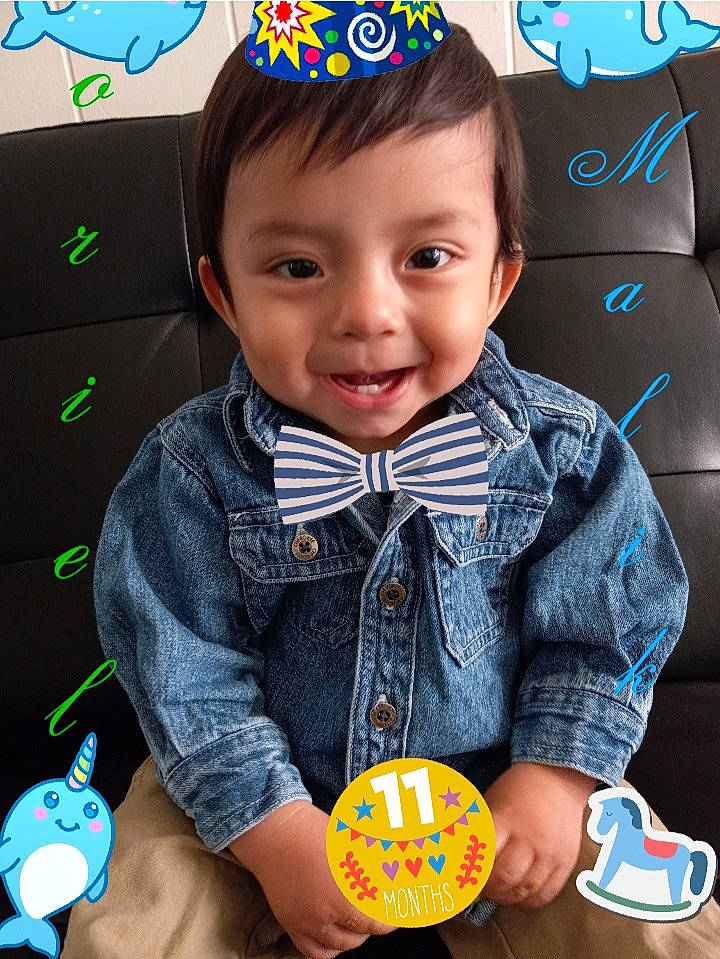 Oriel Malik joined the competition — help win amazing prizes! baby_playing_with_toys, baby_toddler_clothing, blue, child, cool, facial_expression, finger, fun, gesture, hairstyle, happy, head, joy, organ, person, photograph, product, skin, sleeve, smile