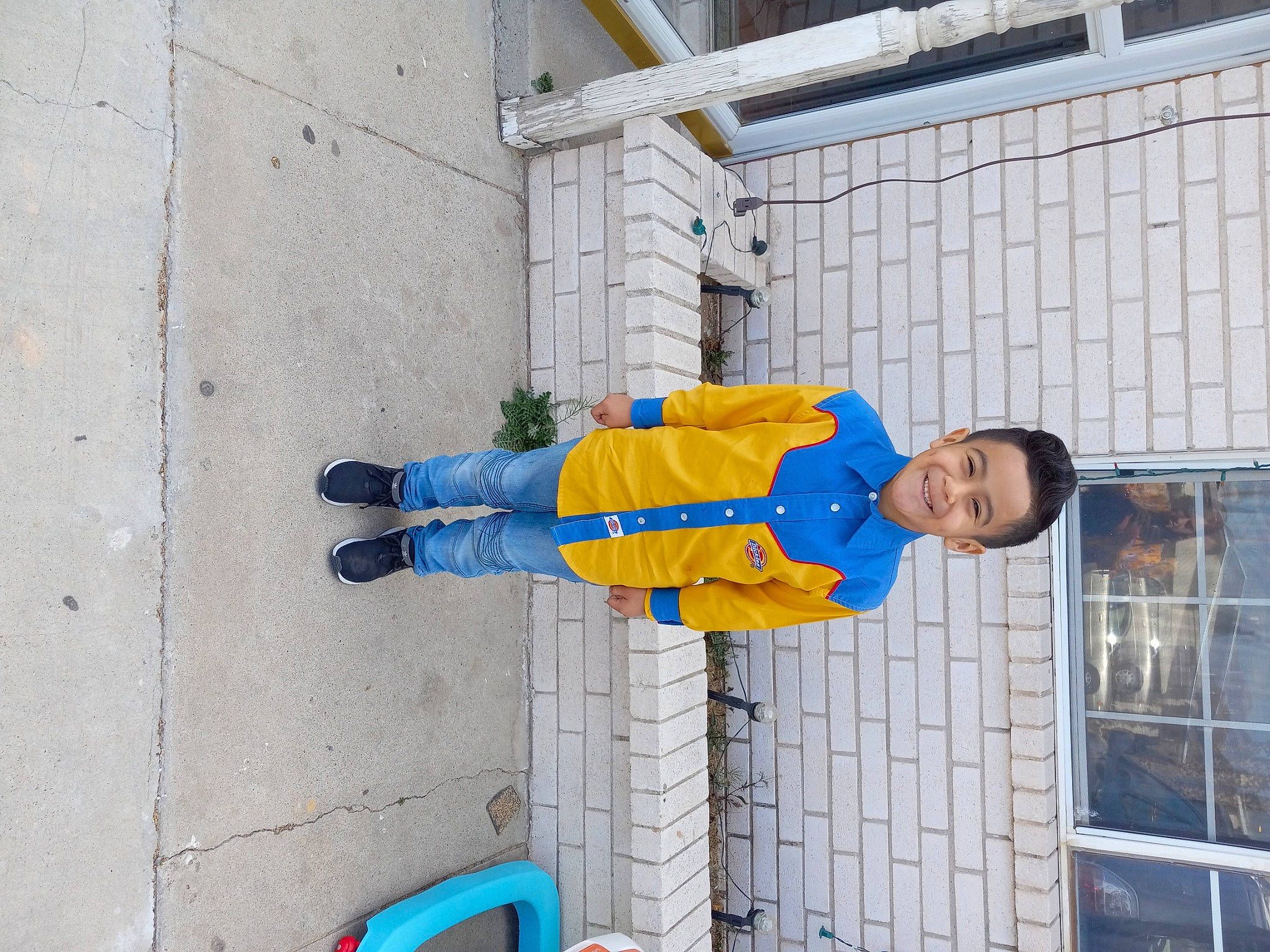 Zohan is registered to the contest to win money with this photo: baby_toddler_clothing, blue, building, child, cleanliness, composite_material, concrete, electric_blue, facade, hat, jacket, joy, outdoor_shoe, person, toddler, walking_shoe