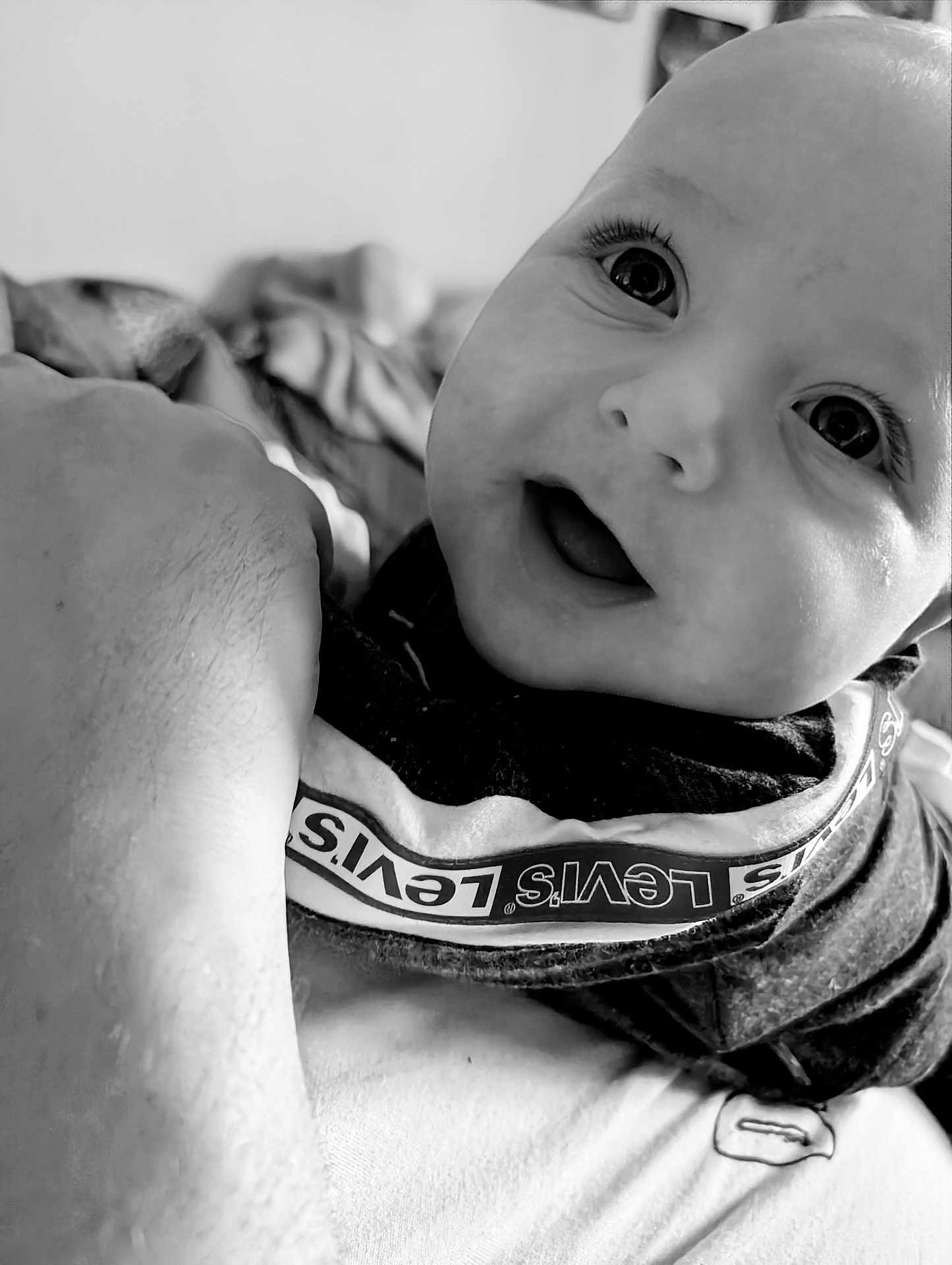 Kaizer joined the competition — help win amazing prizes! baby, child, face, smile, eyes, clothing, levis, black_and_white, portrait, happy, close_up, infant, person, arm, fabric, texture, indoor, expression, young, cute