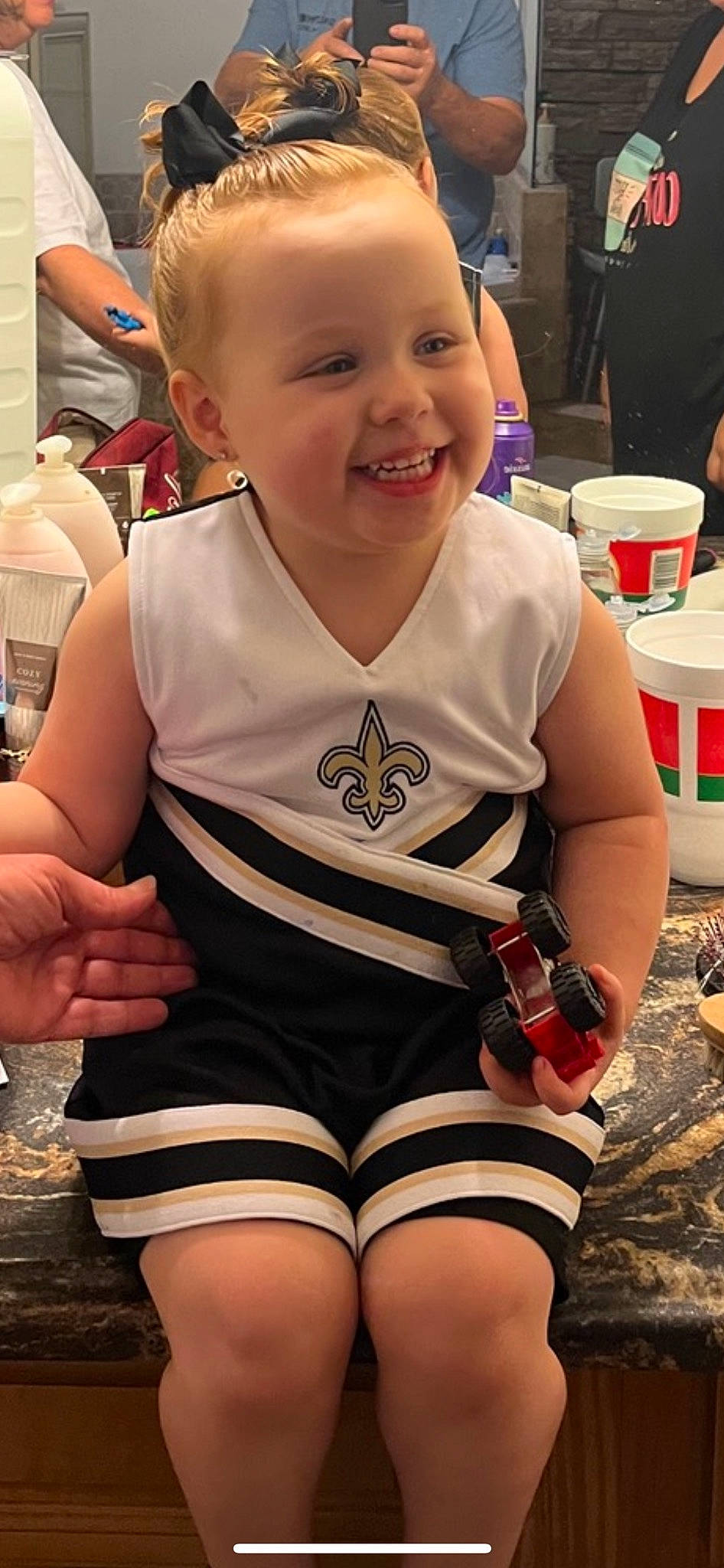 Callie is registered to the contest to win money with this photo: abdomen, blond, chest, fun, hairstyle, happy, human_leg, jersey, joy, knee, person, personal_protective_equipment, recreation, sleeve, smile, sports_gear, sports_uniform, sportswear, t_shirt, thigh