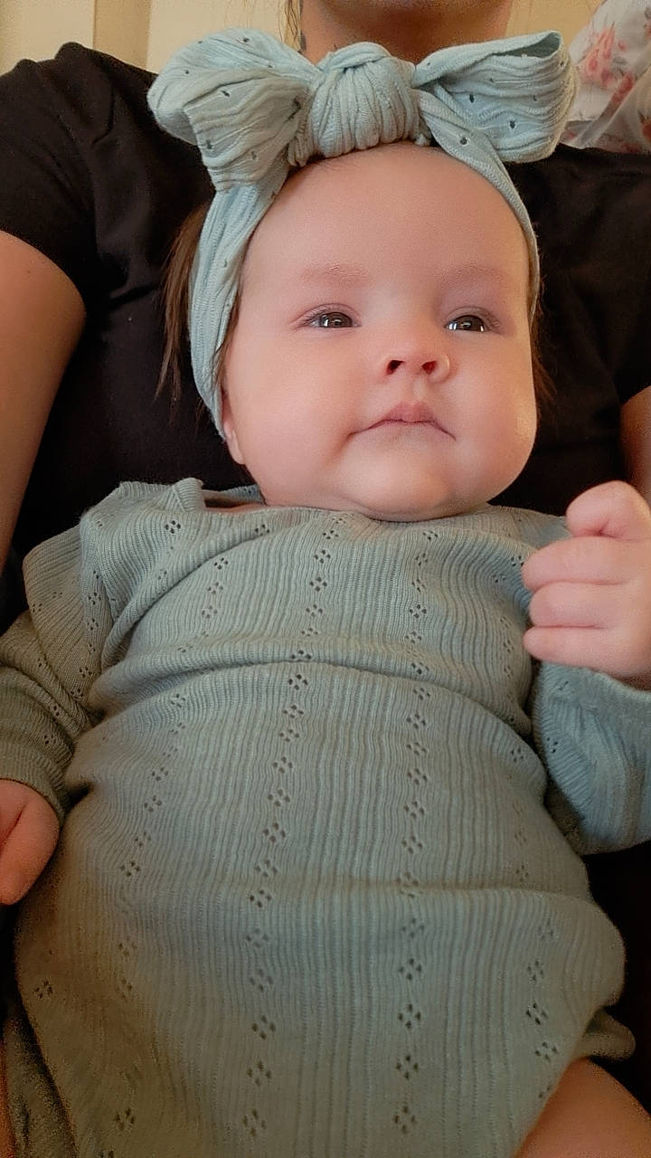 Rebecca is registered to the contest to win money with this photo: baby, baby_toddler_clothing, cheek, chin, comfort, eye, face, facial_expression, finger, head, headgear, human_body, iris, lip, person, pink, skin, sleeve, smile, textile