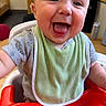 baby, smiling, tongue_out, high_chair, bib, indoor, table, can, clothing, child, person, happy, face, cheerful, cute, infant, tongue, reaching, close_up, seat