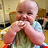 Caspian joined the competition — help win amazing prizes! baby, infant, high_chair, bib, hands, face, smiling, cheeks, indoor, furniture, crib, child, cute, mouthing, person, table, clothing, playroom, skin, happy