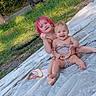 child, baby, toddler, smiling, happy, pink_hair, outdoor, backyard, grass, portrait, sitting, lying_down, infant, siblings, playful, blanket, sheet, sunlight, wheelie_bin, family