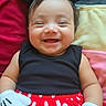 baby, child, smiling, happy, portrait, minnie_mouse, mouse_ears, hair_bow, red_skirt, polka_dots, black_shirt, costume, gloves, lying_down, indoors, cushions, colorful, mickey_mouse, infant, close_up